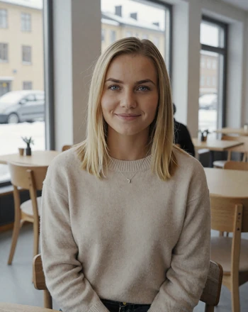 Maja, 33, Swedish woman from Stockholm with calm smile in a bright Scandinavian cafe